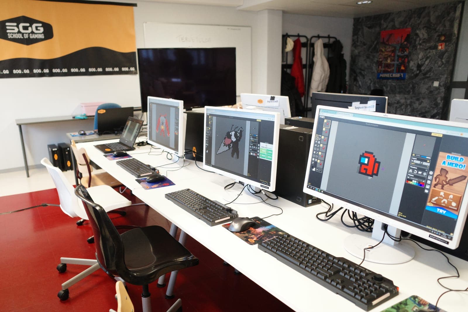 A row of computers with drawing programs open in our studio, ready for a club